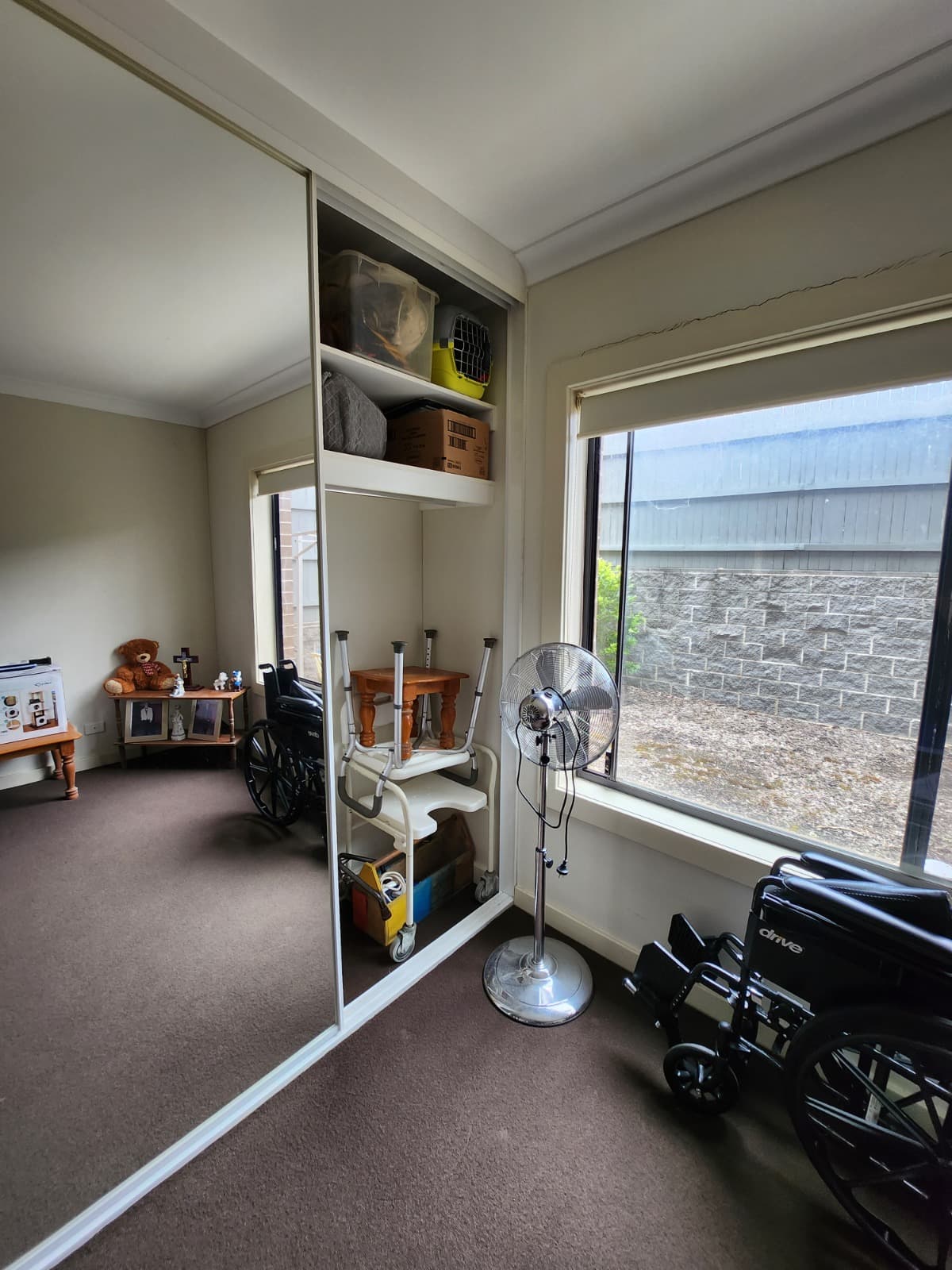Organised wardrobe and clear access for mobility equipment