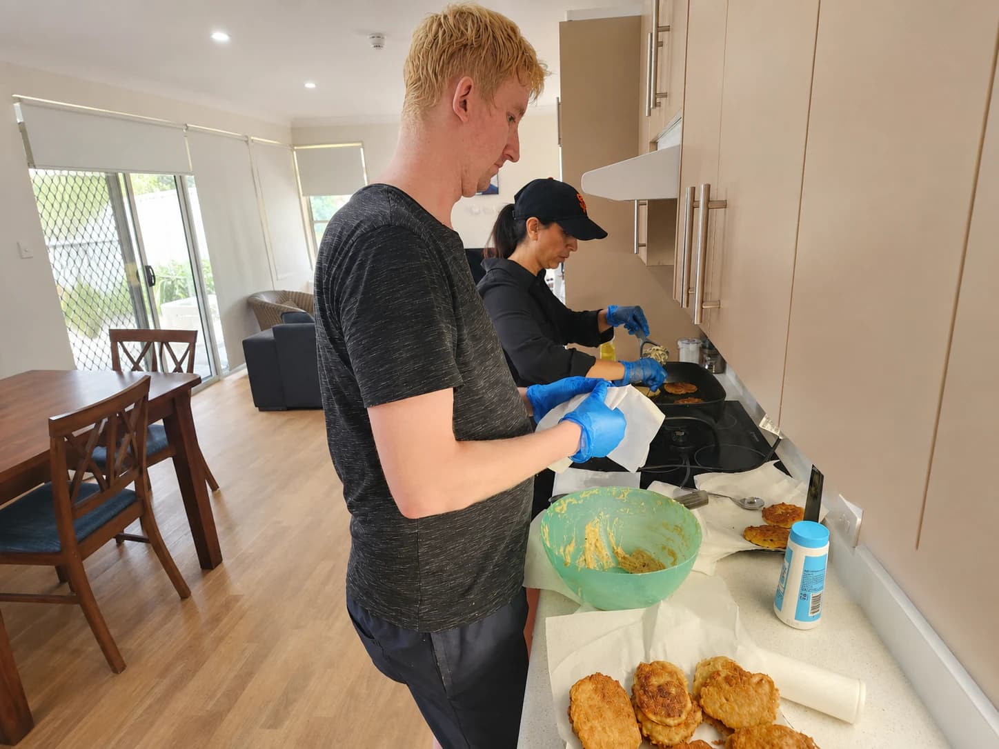 Participant building daily living skills through supported cooking at home